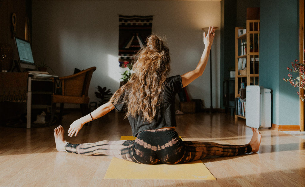 young woman moving through yoga pose